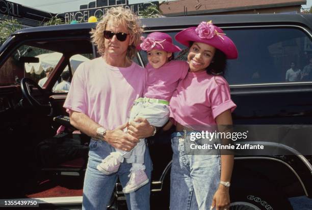 American radio personality Shadoe Stevens with his wife Beverly Cunningham and daughter, Amber, both mother and daughter wear matching pink hats and...