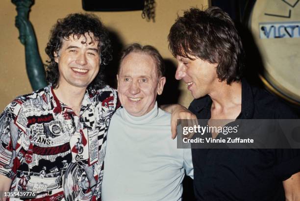 British guitarist and songwriter Jimmy Page with his arm around American guitarist, songwriter, and luthier Les Paul , with British guitarist and...