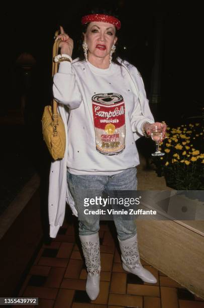 American astrologer Jackie Stallone , wearing a white sweatshirt with an image of a Campbell's condensed chicken and rice soup can, attends Jim...