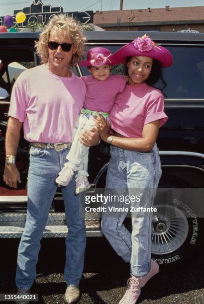 American radio personality Shadoe Stevens with his wife Beverly Cunningham and daughter, Amber, both mother and daughter wear matching pink hats and...