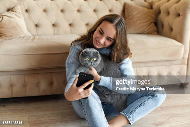 young beautiful girl with a pet cat. - cat selfie stock pictures, royalty-free photos & images