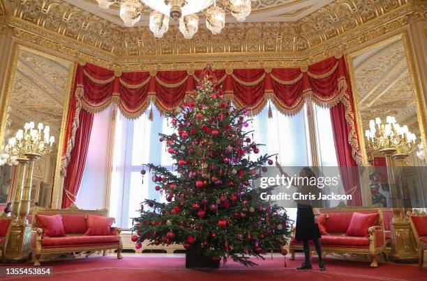 General view of a 15-foot-high Christmas tree in the Crimson Drawing Room at Windsor Castle on November 25, 2021 in Windsor, England. The decorations...