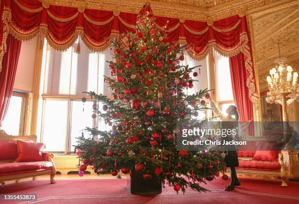 General view of a 15-foot-high Christmas tree in the Crimson Drawing Room at Windsor Castle on November 25, 2021 in Windsor, England. The decorations...