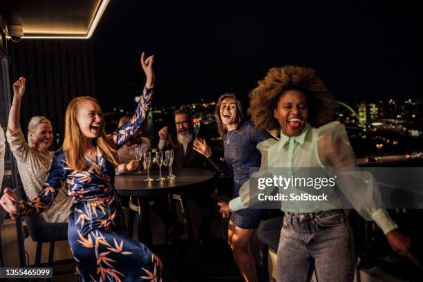 partying the night away - champagne rooftop stock pictures, royalty-free photos & images