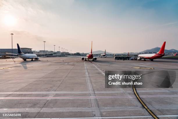 airplane on airport runway against sky - jet tarmac stock pictures, royalty-free photos & images