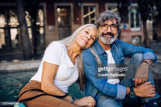 portrait of a happy mature couple enjoying their romantic vacation in barcelona - mature adult couple stockfoto's en -beelden