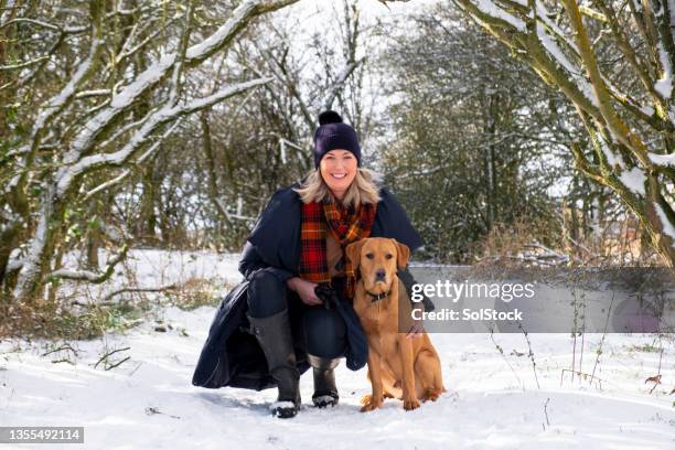 me & my puppy in the snow - mature adult walking dog stock pictures, royalty-free photos & images