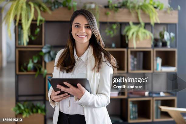successful business woman using a tablet computer at the office - businesswoman bildbanksfoton och bilder