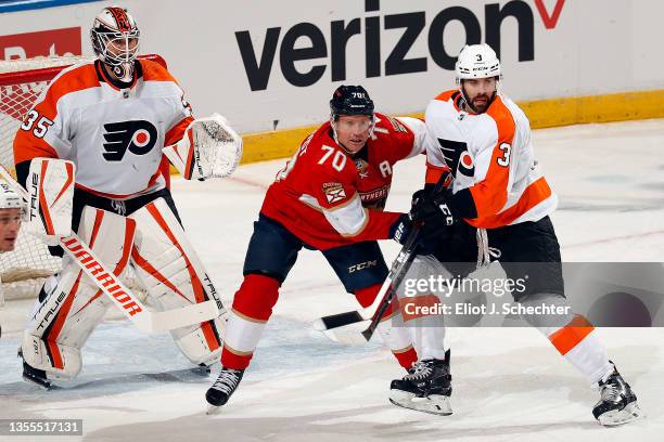 Goaltender Martin Jones of the Philadelphia Flyers defends the net with the help of teammate Keith Yandle against Patric Hornqvist of the Florida...