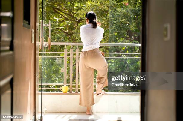 woman admiring view from balcony - women india partition stock pictures, royalty-free photos & images