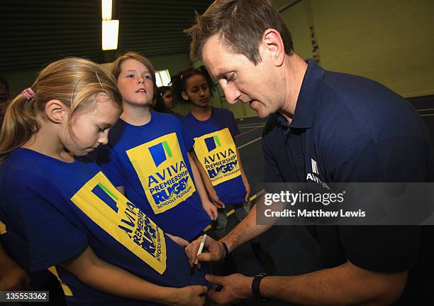 Ex-England and Harlequins rugby player Will Greenwood signs autographs for children from Fosse Primary School during an Aviva Premiership Rugby...