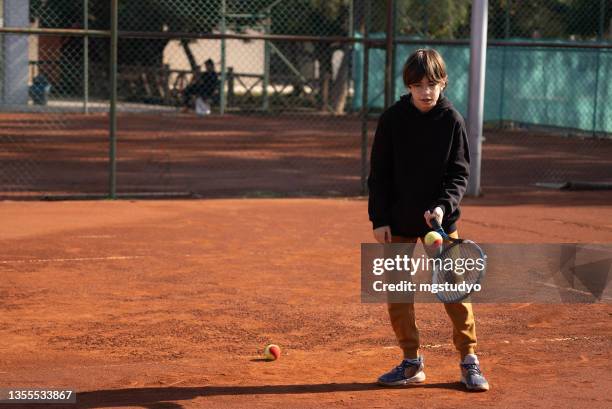 boy playing tennis - tennis racquet stock pictures, royalty-free photos & images