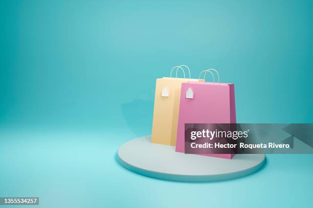 3d render of two yellow and pink paper shopping bags in blue background - concept store fotografías e imágenes de stock