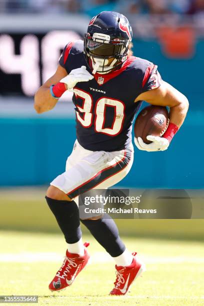 Phillip Lindsay of the Houston Texans runs with the ball against the Miami Dolphins at Hard Rock Stadium on November 07, 2021 in Miami Gardens,...