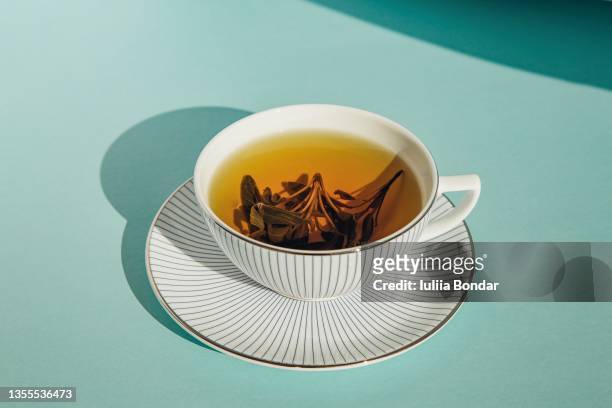 herbal tea in white cup - untertasse stock-fotos und bilder