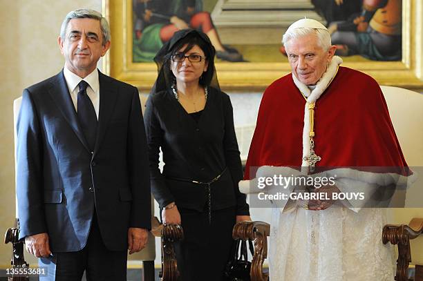 Pope Benedict XVI greets Armenia's President Serzh Sargsyan during a private audience on December 12, 2011 at The Vatican. At center is an...