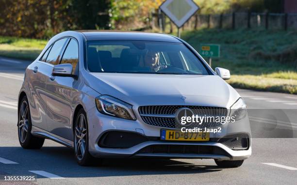 dutch gray 2015 mercedes a180 driving on the n35 at wierden - luxeauto stockfoto's en -beelden