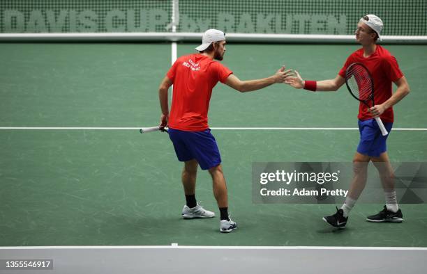 Jiri Lehecka and Tomas Machac of the Czech Republic celebrate winning a point over Pierre-Hugues Herbert and Nicolas Mahut of France during the group...