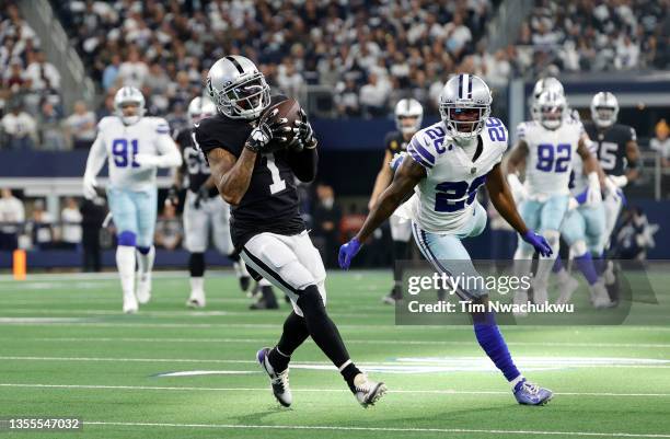 DeSean Jackson of the Las Vegas Raiders makes a reception under pressure from Jourdan Lewis of the Dallas Cowboys prior to scoring his sides first...