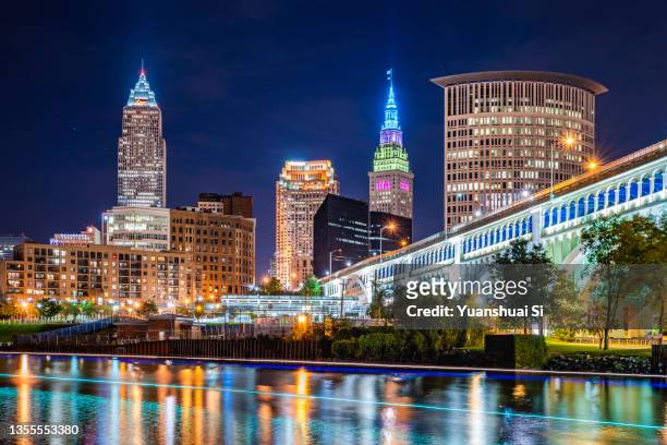 cleveland skyline along cuyahoga river - cleveland ohio stock pictures, royalty-free photos & images