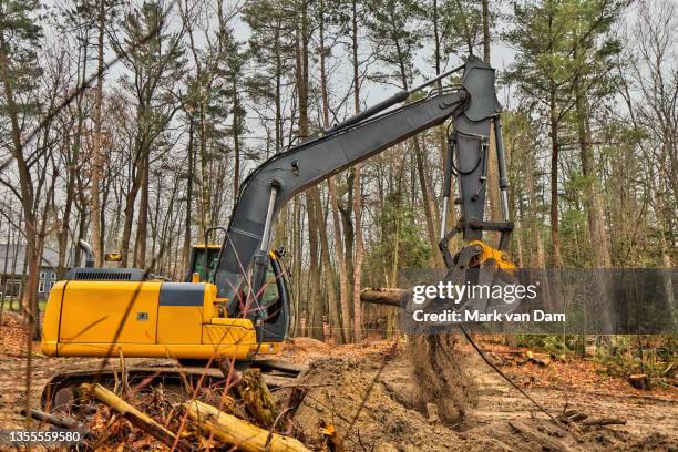 excavator clearing forested residential building lot - grävmaskin bildbanksfoton och bilder