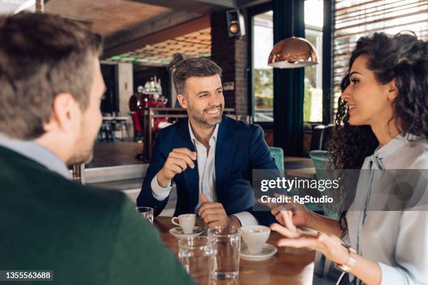 group of entrepreneurs enjoying coffee after work - working lunch stock pictures, royalty-free photos & images