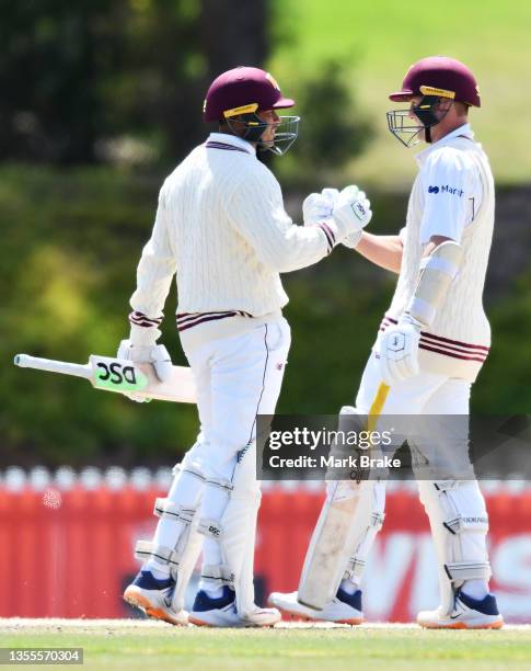 Usman Khawaja of the Queensland Bulls celebrates making his half century and winning the game with Marnus Labuschagne of the Queensland Bulls during...