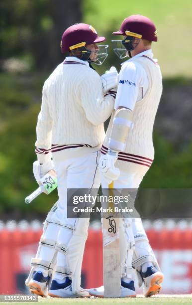Usman Khawaja of the Queensland Bulls celebrates making his half century and winning the game with Marnus Labuschagne of the Queensland Bulls during...