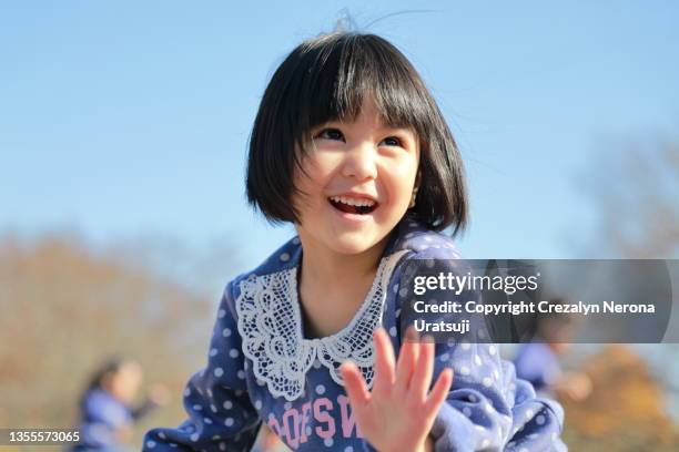 little girl having fun outdoor - 子供　日本人　笑顔 ストックフォトと画像