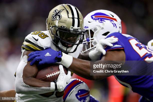 Ty Montgomery of the New Orleans Saints is tackled by Greg Rousseau of the Buffalo Bills during the first quarter at Caesars Superdome on November...