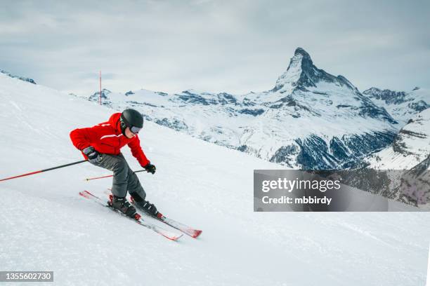 young skier downhill skiing at zermatt ski resort, switzerland - zermatt skiing stock pictures, royalty-free photos & images