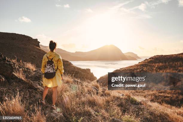 woman enjoying sunrise over ponta de são lourenço in madeira portugal - madeira stock pictures, royalty-free photos & images