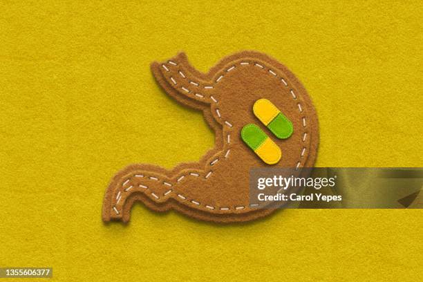 stomach made of browm felt with pill inside.gerd - oesophagus stock pictures, royalty-free photos & images