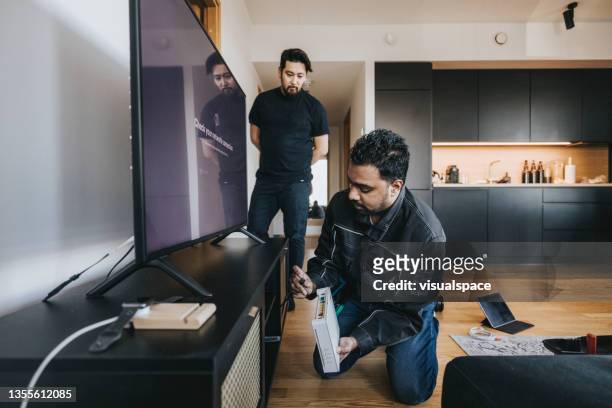 it technician installing wifi router - cable installation stock pictures, royalty-free photos & images