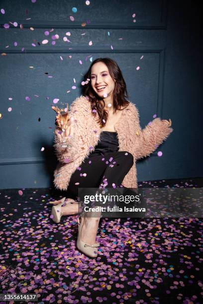 excited woman with champagne throwing confetti - fashion party stock pictures, royalty-free photos & images