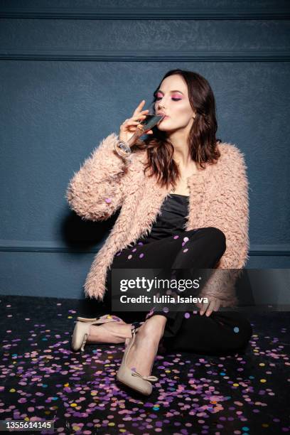 stylish woman drinking champagne for new year celebration - glitter shoes stock pictures, royalty-free photos & images