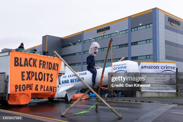 Extinction Rebellion protesters block an Amazon fulfillment centre on November 26, 2021 in Tilbury, England. Extinction Rebellion have blockaded...