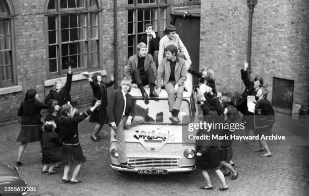 English rock band the Yardbirds pose on their Ford Thames van surrounded by schoolgirls to promote their single 'Good Morning Little Schoolgirl',...