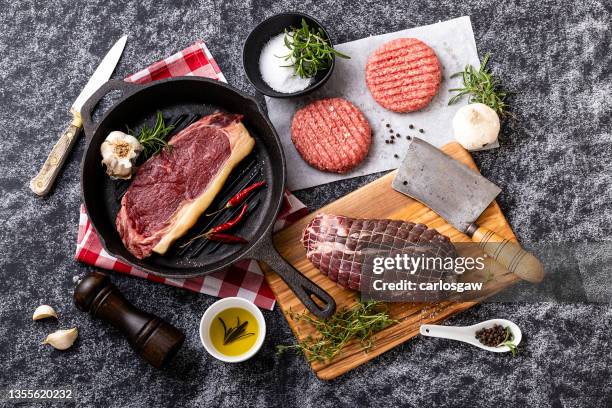 different cuts of raw meat on black background - pepper pot stock pictures, royalty-free photos & images