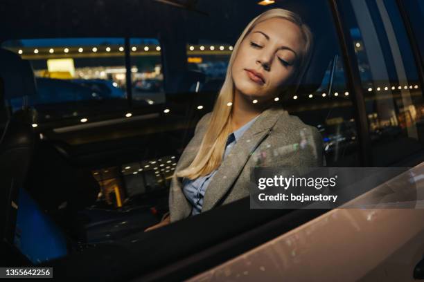 tired businesswoman sleeping in taxi - sleeping in car stock pictures, royalty-free photos & images