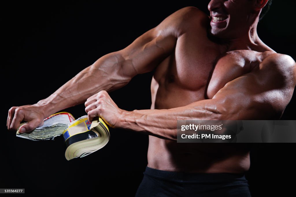 Strong Man Ripping Phone Book High-Res Stock Photo - Getty Images