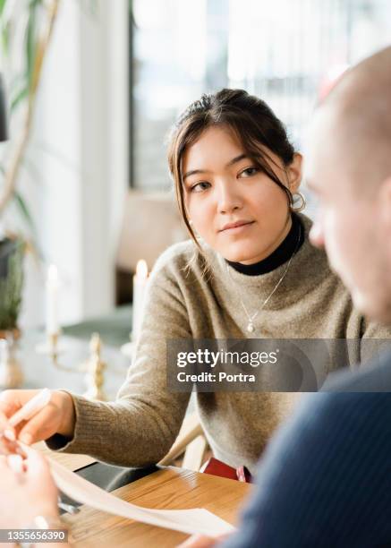 businesswoman sitting in the boardroom during her job interview - recruiter bildbanksfoton och bilder