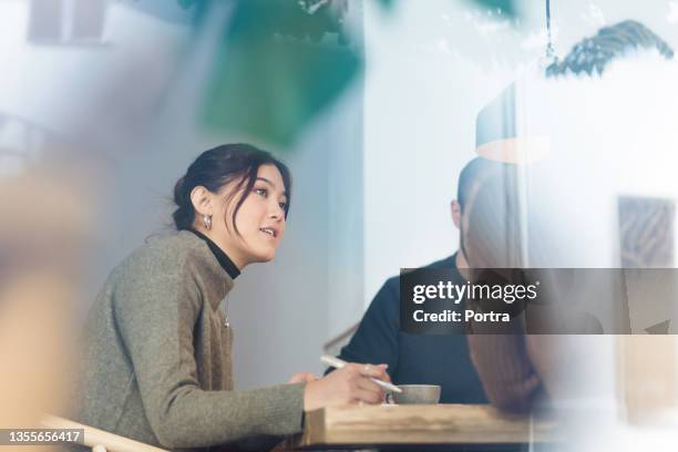 employer interviewing a job applicant inside office boardroom - performance evaluation stock pictures, royalty-free photos & images