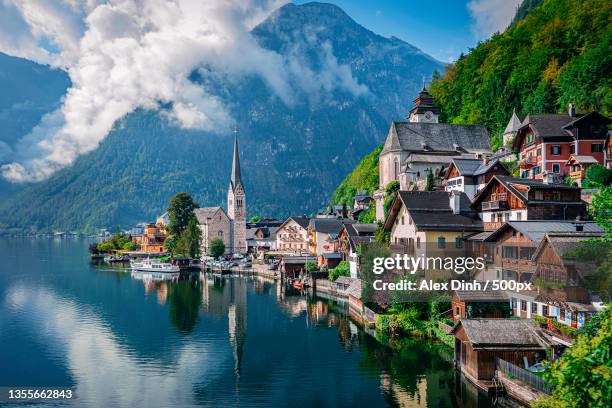 hallstatt,austria,panoramic view of buildings and mountains against sky - hallstatt stock pictures, royalty-free photos & images