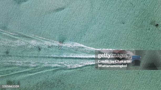 speedboat journey in the sea - aerial view. - aerial single object stock pictures, royalty-free photos & images