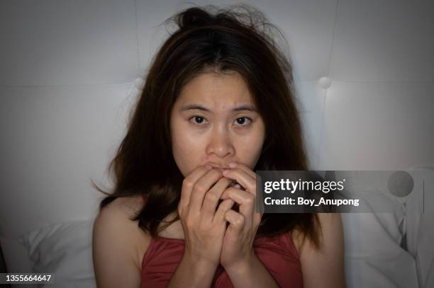 portrait of young asian woman having frightened or worried about something in the night time. - defeat fear stock pictures, royalty-free photos & images