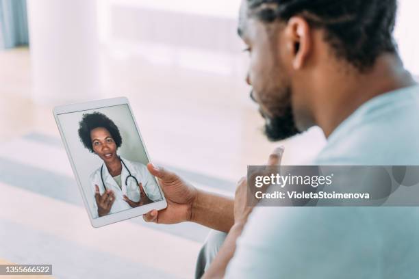 video call with doctor. - man talking to doctor stock pictures, royalty-free photos & images