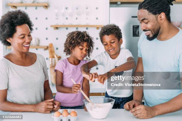 family cooking together. - crack spoon stock pictures, royalty-free photos & images
