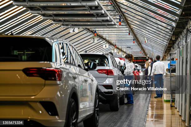 Mask-clad workers perform final quality control to new T-Roc vehicles during the visit by Portuguese Prime Minister Antonio Costa and Portuguese...