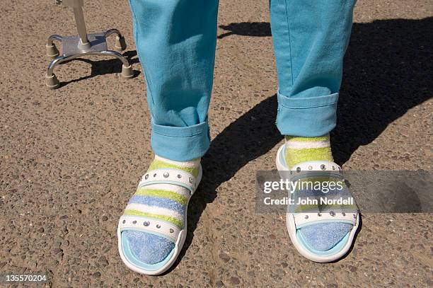 old woman sporting bright pants, socks, and sandals - uncool fotografías e imágenes de stock